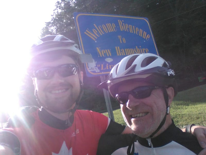 James and Chris pose in front of the Welcome to New Hampshire sign