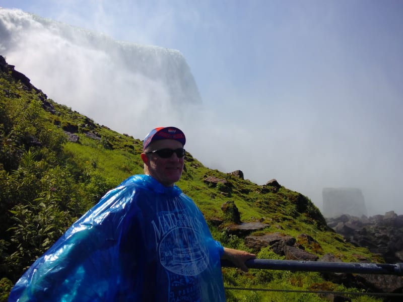 Chris wears his "Maid of the Mist" poncho and stands in front of the US falls
